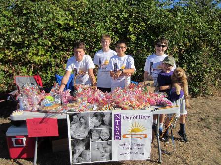 family raising funds with a bake sale