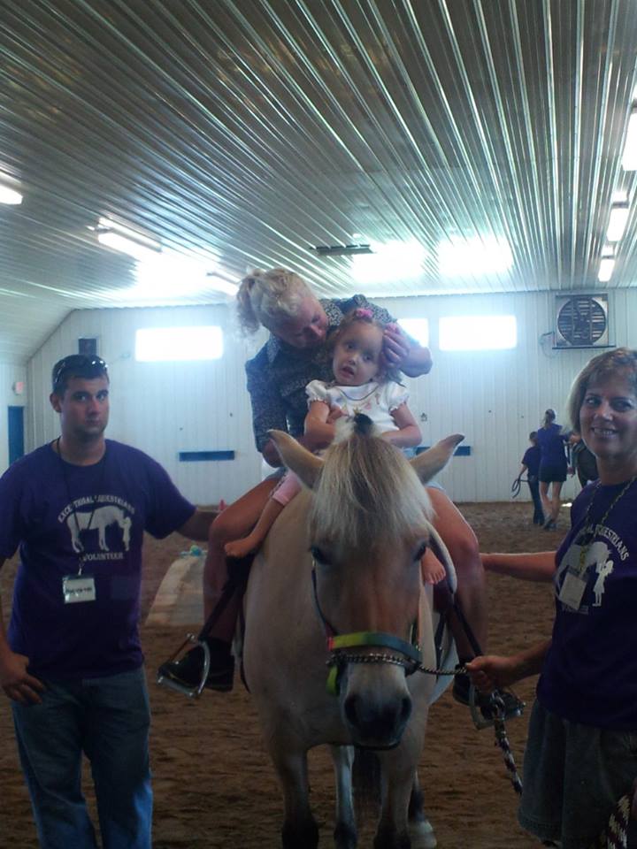 Lilliana horse rides with a therapist